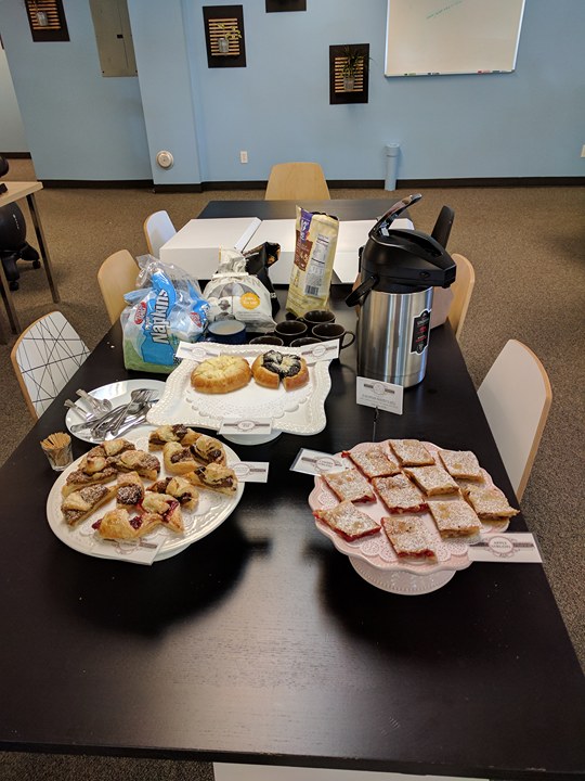 Photo of food and coffee on conference table